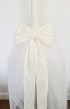 Load image into Gallery viewer, The Mila Bow Orthodox Candle is made up or Pearl Lace and completed with a full Tulle Skirt.