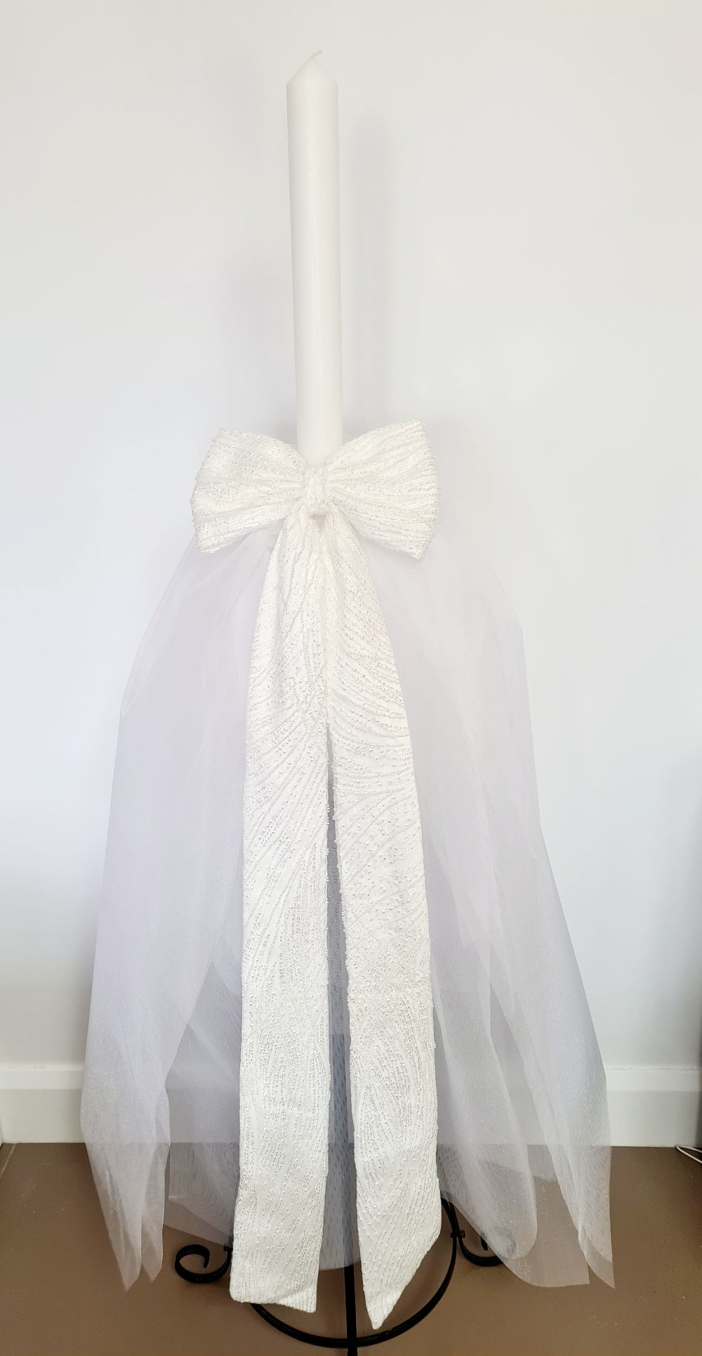 The Mila Bow Orthodox Candle is made up or Pearl Lace and completed with a full Tulle Skirt.